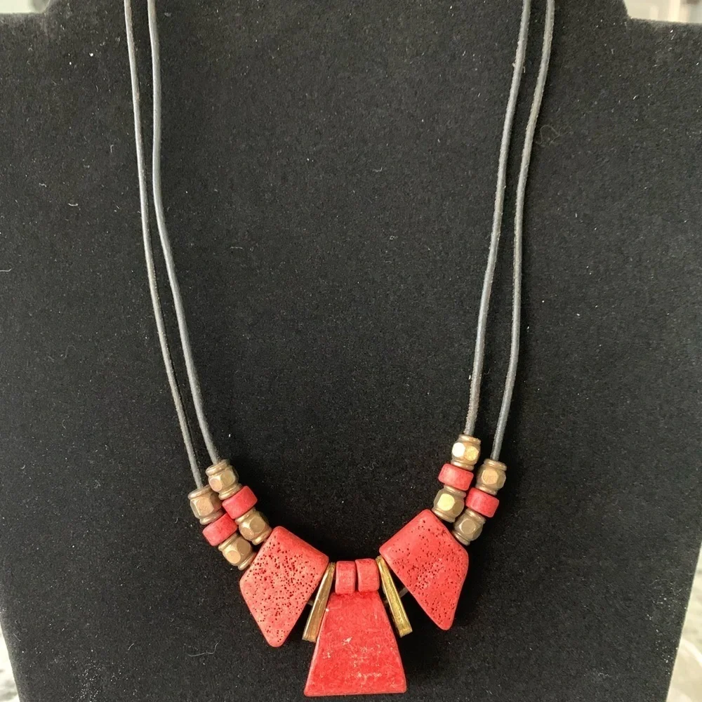 Vintage coral and gold‎ colored beaded necklace on a leather chain.